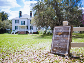 Rustic sign with bride and groom names greets wedding ceremony guests at Hopsewee Plantation. Photo by Mick Schulte.