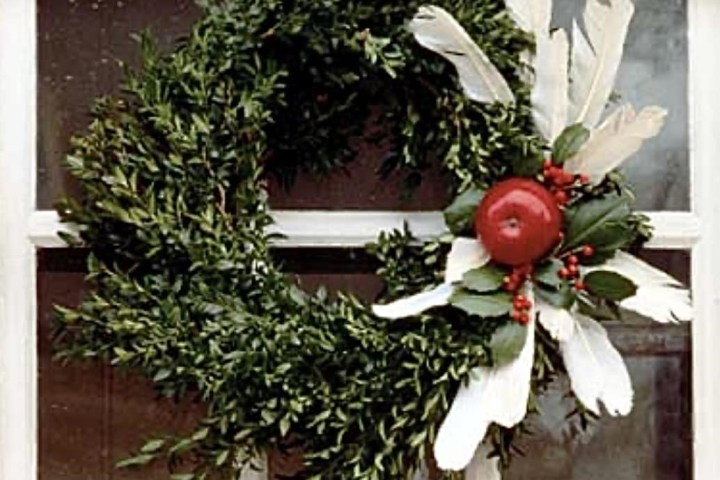 a vase of flowers sits in front of a building