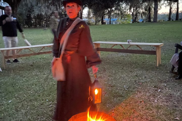 a person standing next to a fire hydrant in the grass