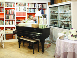 hopsewee-dining-river-oak-tea-room-interior a living room filled with furniture and a book shelf
