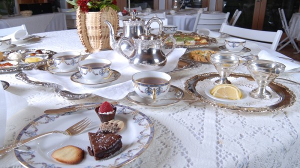 a group of people sitting at a table with a plate of food