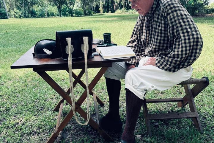 a person sitting on a bench in a park