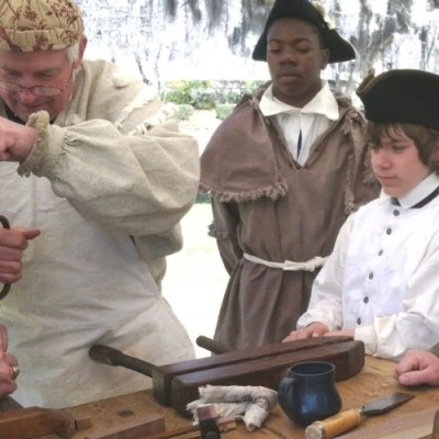 REVOLUTIONARY WAR REENACTORS a group of people around each other