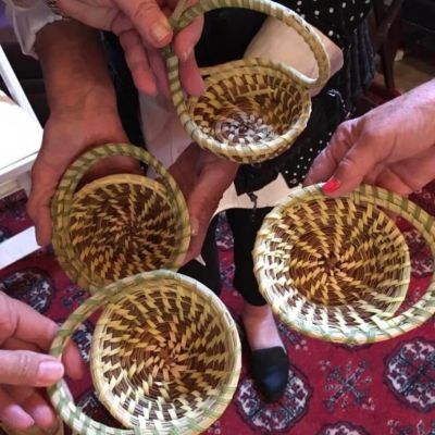 Sweetgrass basketmaking a basket of food on a table