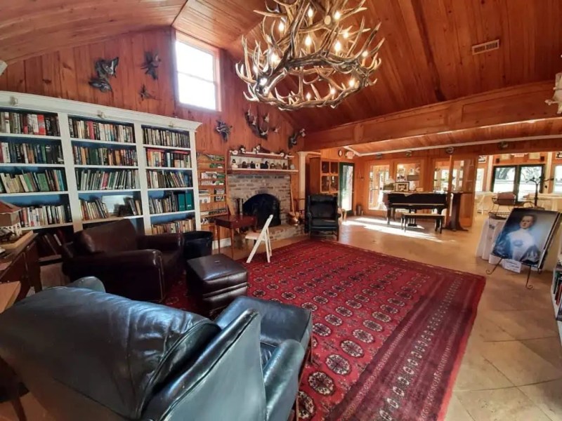 a living room filled with furniture and a large window
