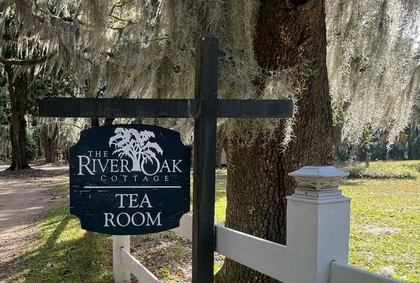 Sign for River Oak Cottage Tea Room by a tree with Spanish moss.